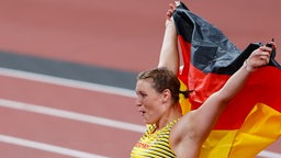 Die deutsche Diskuswerferin Kristin Pudenz jubelt über Silber mit der Nationalflagge. © /dpa +++ dpa-Bildfunk Foto: Swen Pförtner